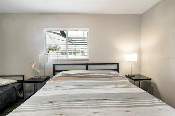 a bedroom with a large bed and a window