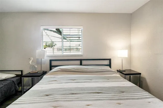 a bedroom with a large bed and a window