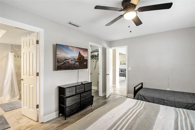 a bedroom with a bed and a flat screen tv