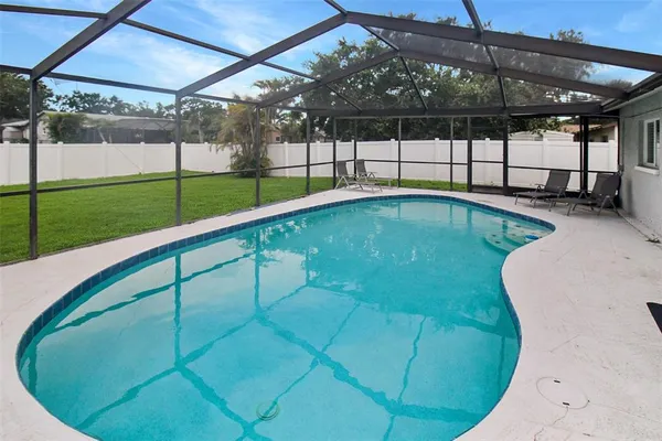 a view of a backyard with swimming pool