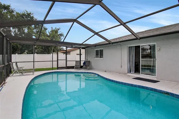 a view of a backyard with a swimming pool
