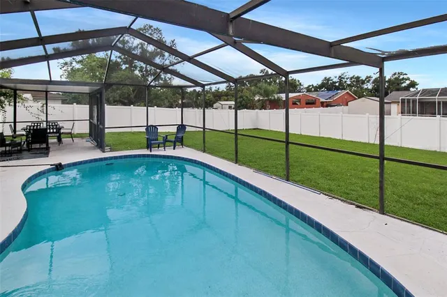 a view of a backyard with a swimming pool