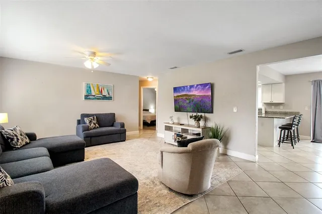 a living room with furniture a dining table and a piano