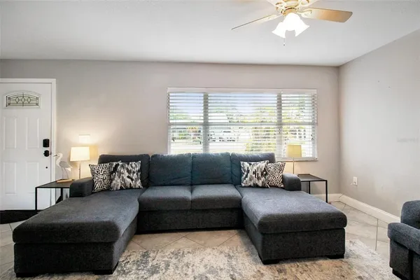 a living room with furniture and a large window