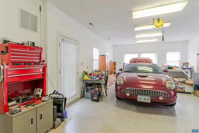 a view of a green field with wooden fence