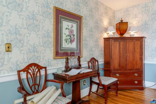 a view of a dining room with furniture a chandelier and wooden floor