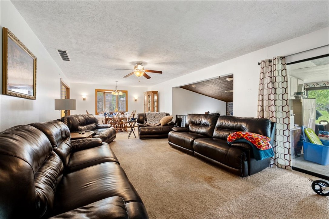 7225 Garber Road Clayton, OH 45415 - Photo 19 of 33 This expansive living space features plush carpet and ample seating, perfect for gatherings.