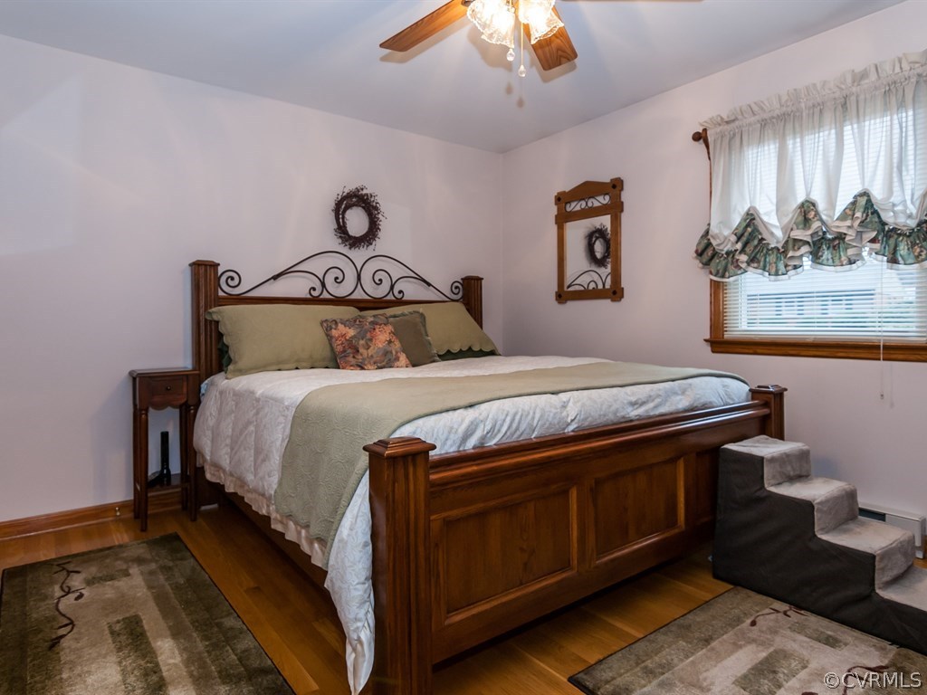 2209 Staten Road Chester, VA 23831 - Photo 16 of 24 a bedroom with a bed and a chandelier