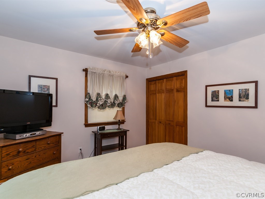 2209 Staten Road Chester, VA 23831 - Photo 17 of 24 a bedroom with a bed and a flat screen tv
