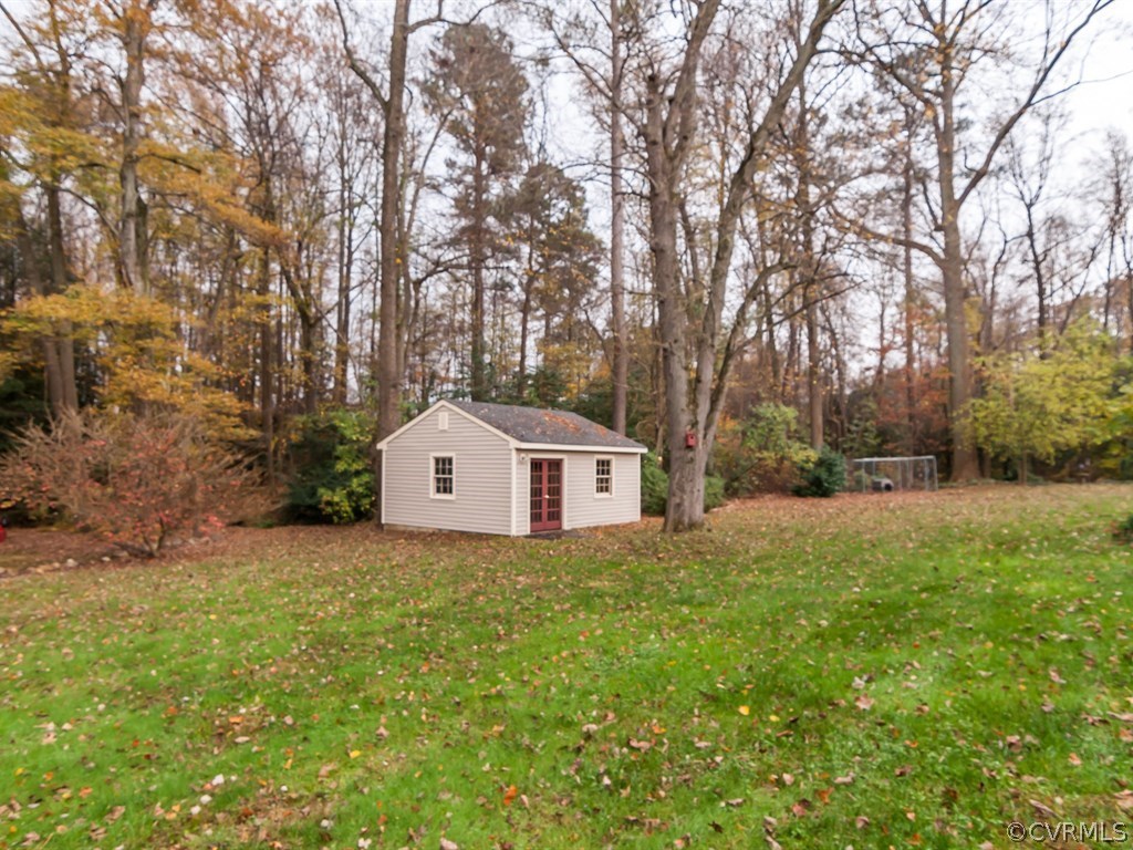 2209 Staten Road Chester, VA 23831 - Photo 21 of 24 a front view of a house with a yard and large trees