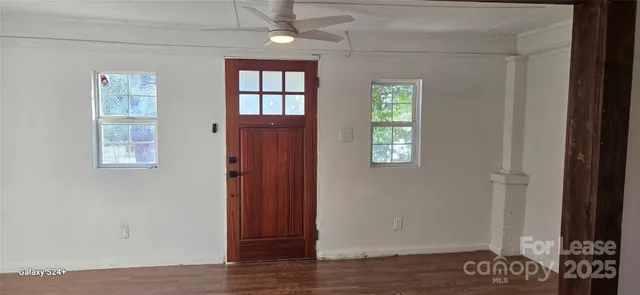 a view of an entryway with wooden floor