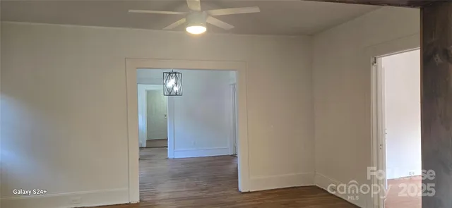 a view of a room with wooden floor