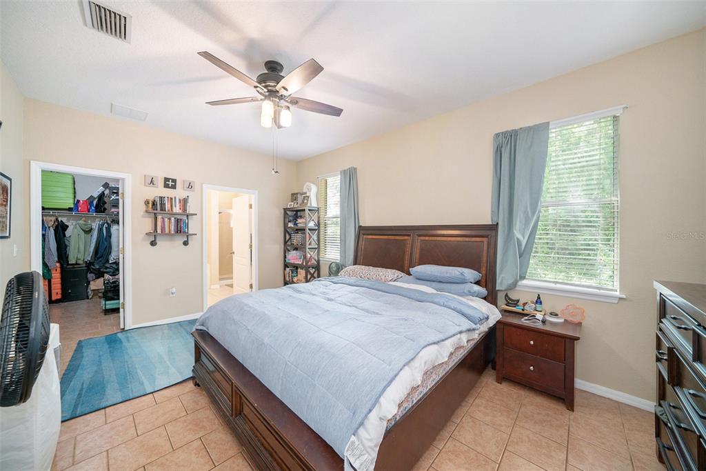 12045 Colony Lakes Boulevard New Port Richey, FL 34654 - Photo 11 of 22 a spacious bedroom with a bed and a large window