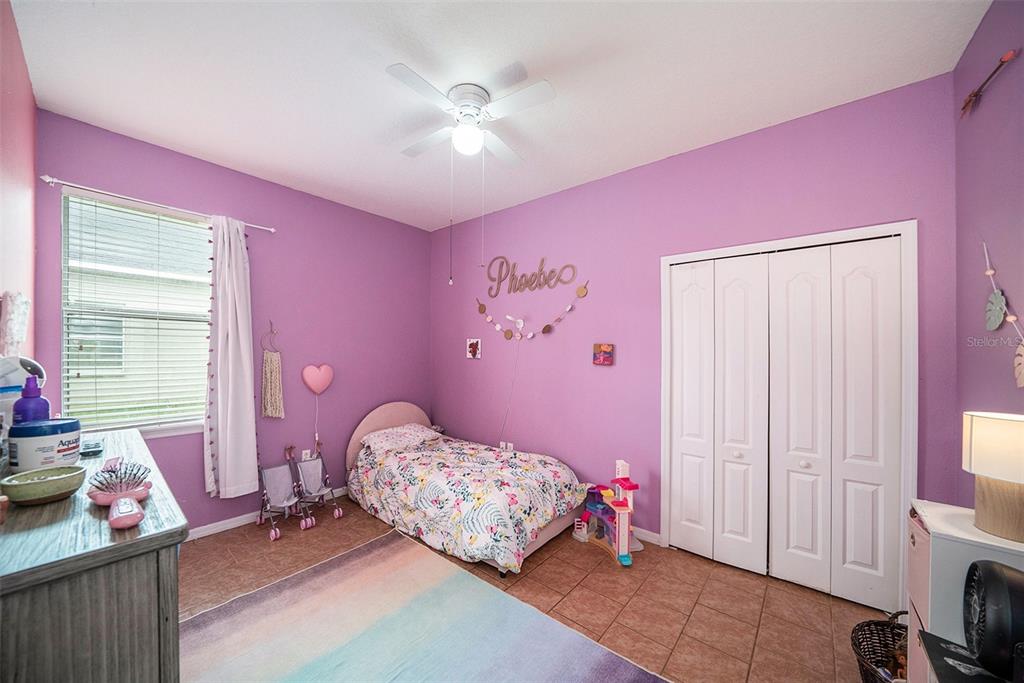 12045 Colony Lakes Boulevard New Port Richey, FL 34654 - Photo 13 of 22 a bedroom with a bed and a window
