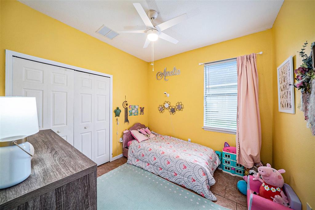 12045 Colony Lakes Boulevard New Port Richey, FL 34654 - Photo 14 of 22 a bedroom with a bed and a window