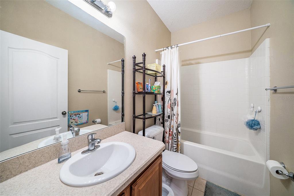 12045 Colony Lakes Boulevard New Port Richey, FL 34654 - Photo 15 of 22 a bathroom with a sink toilet and shower