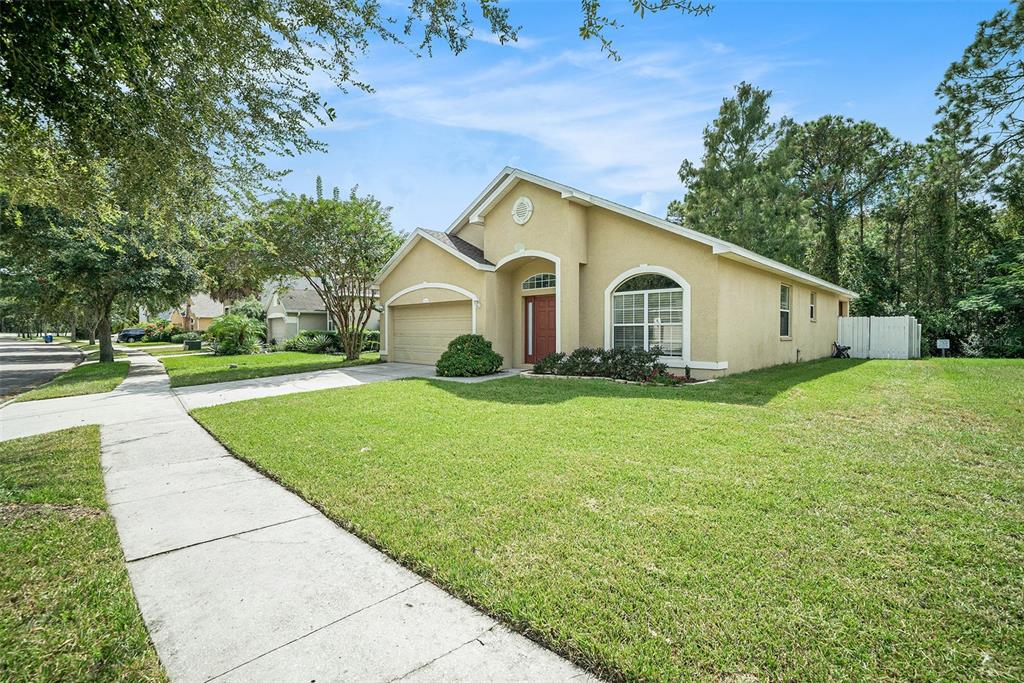 12045 Colony Lakes Boulevard New Port Richey, FL 34654 - Photo 2 of 22 a view of a house with a yard