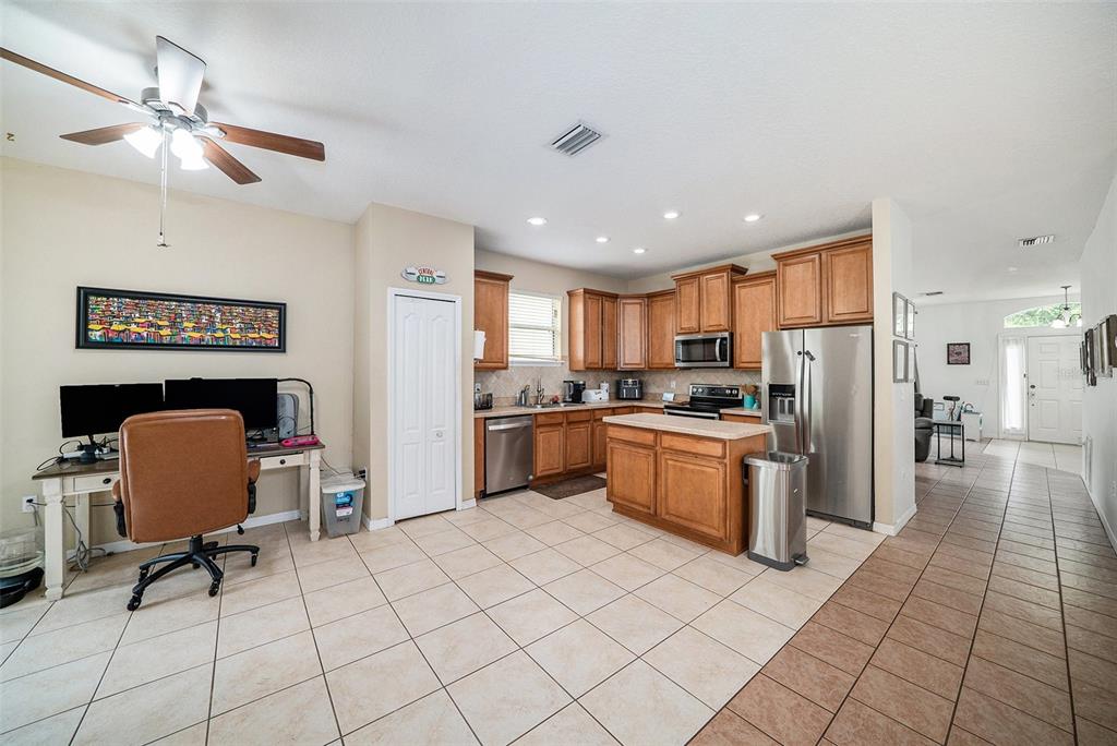 12045 Colony Lakes Boulevard New Port Richey, FL 34654 - Photo 5 of 22 a kitchen with stainless steel appliances granite countertop a refrigerator and a stove top oven