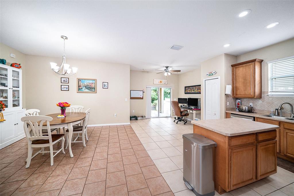12045 Colony Lakes Boulevard New Port Richey, FL 34654 - Photo 6 of 22 a view of a dining room with furniture and a chandelier