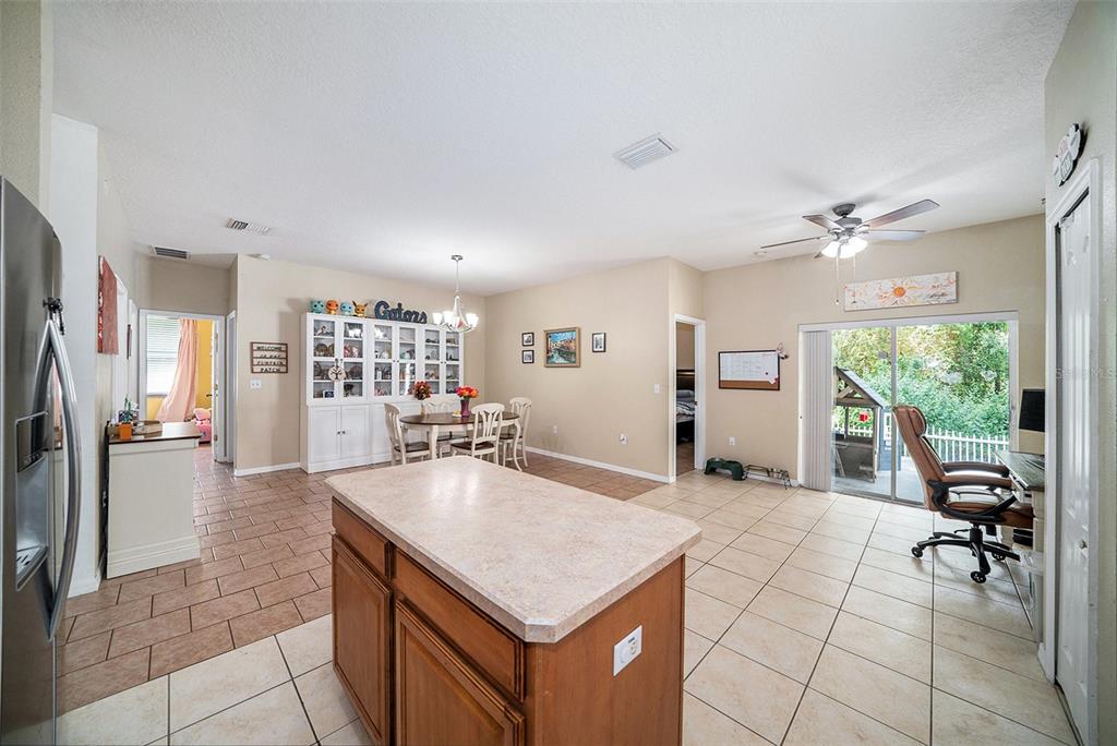 12045 Colony Lakes Boulevard New Port Richey, FL 34654 - Photo 7 of 22 a kitchen with kitchen island a counter top space a sink appliances and cabinets