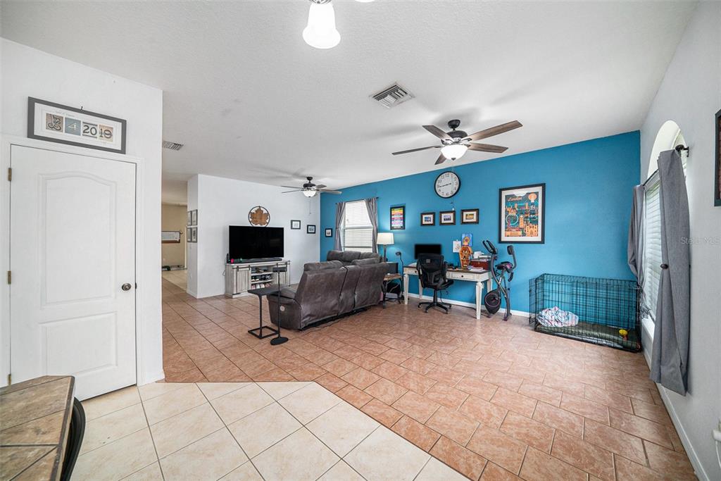 12045 Colony Lakes Boulevard New Port Richey, FL 34654 - Photo 9 of 22 a living room with furniture and a flat screen tv