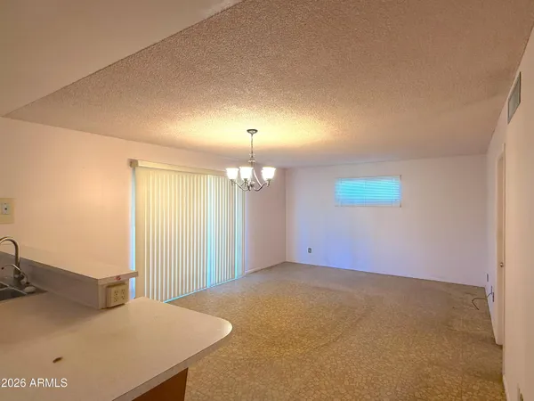 a view of a livingroom with a kitchen