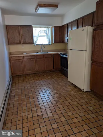 a kitchen with stainless steel appliances a refrigerator sink and cabinets