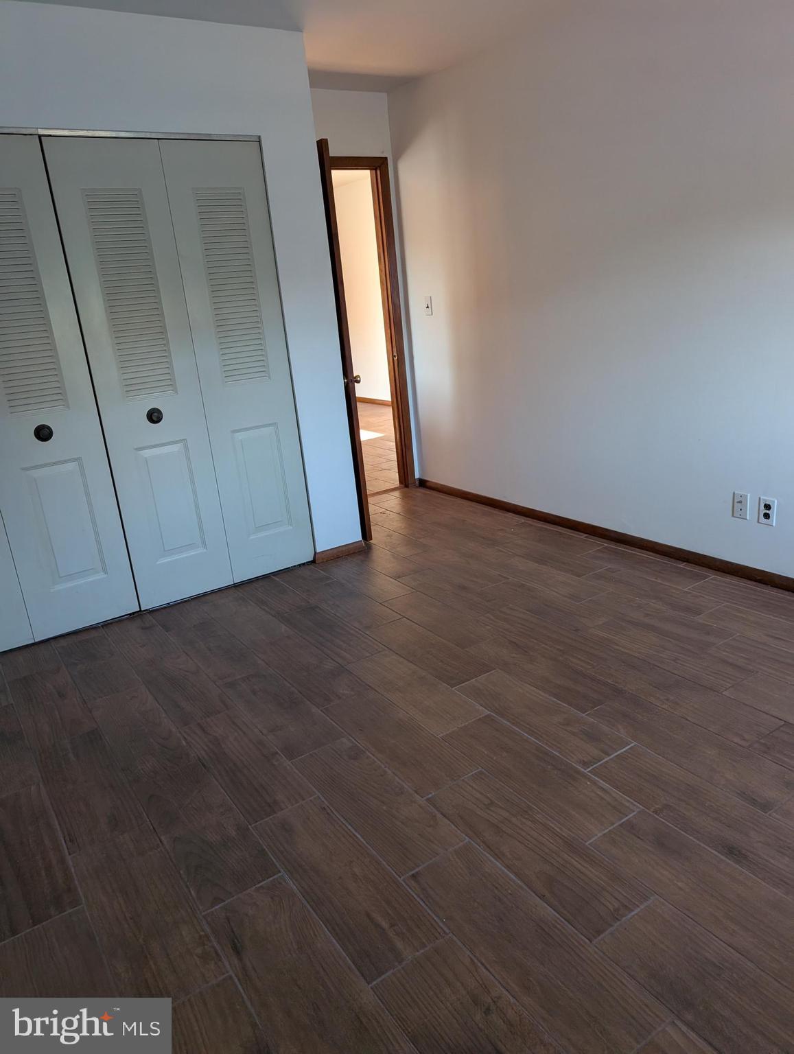 2258 State Rd. Bensalem, PA 19020 - Photo 8 of 13 a view of an empty room with wooden floor and closet