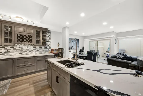 a kitchen with sink stove and white cabinets