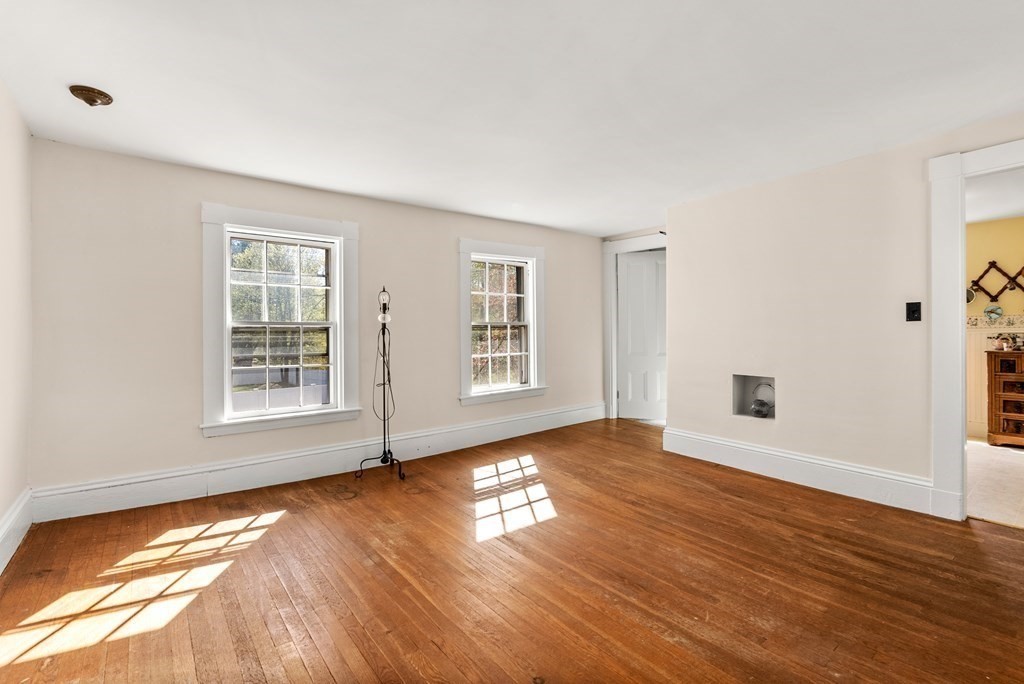 357 Commonwealth Road Wayland, MA 01778 - Photo 17 of 33 a view of an empty room with wooden floor and a window