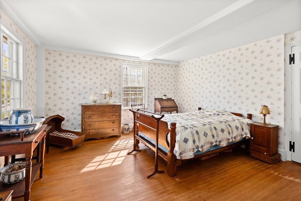 357 Commonwealth Road Wayland, MA 01778 - Photo 19 of 33 a bedroom with a bed and a chair