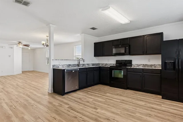 a kitchen with a sink stove and refrigerator