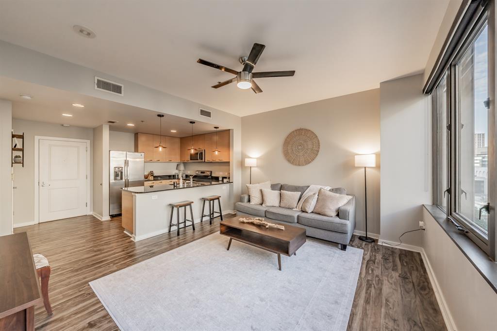 1200 Main Street, Unit 812 Dallas, TX 75202 - Photo 6 of 17 a living room with kitchen island furniture and a wooden floor