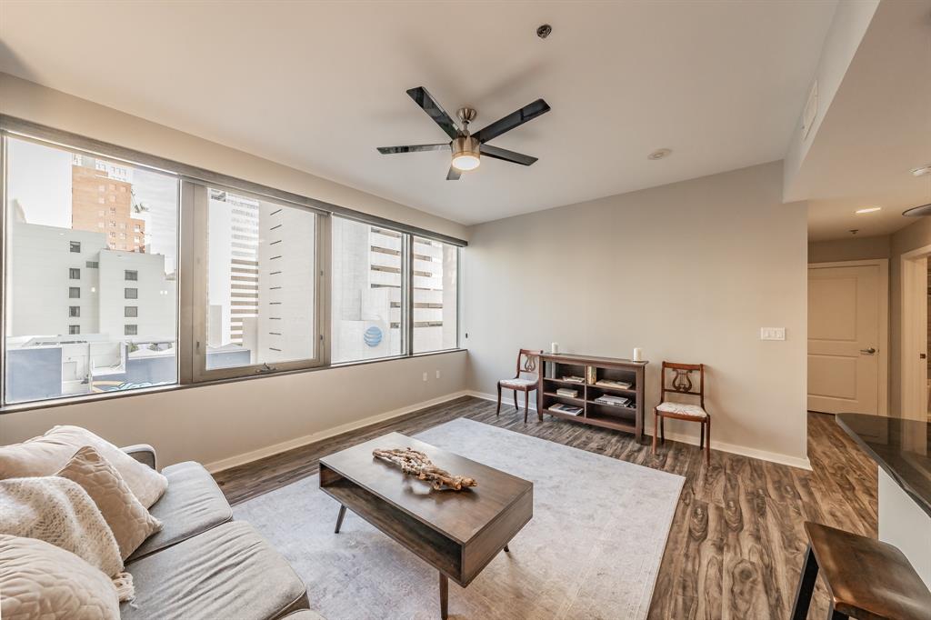 1200 Main Street, Unit 812 Dallas, TX 75202 - Photo 7 of 17 a living room with furniture a table and a large window