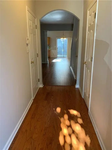 a view of a hallway with wooden floor