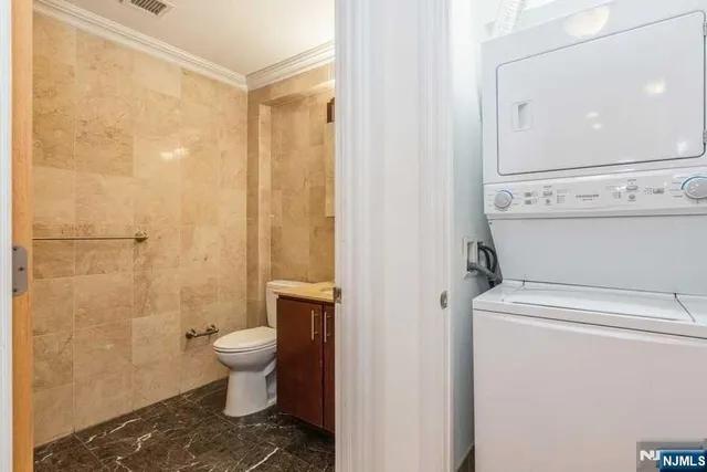 a bathroom with a toilet a sink and shower