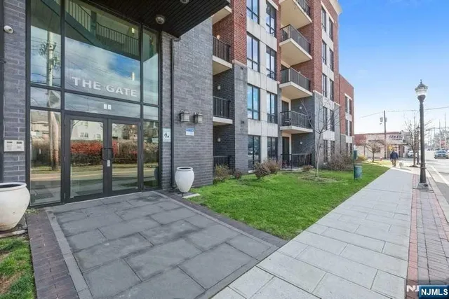 a view of a brick building next to a yard