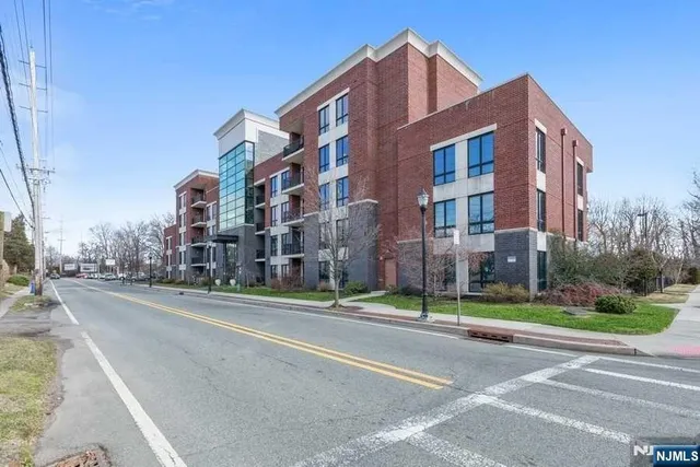 a city street lined with buildings and trees