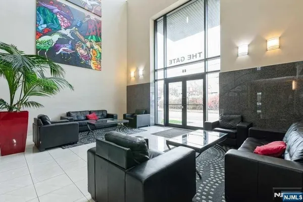 a living room with furniture and a floor to ceiling window