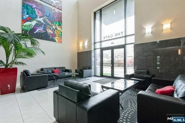 a living room with furniture and a floor to ceiling window