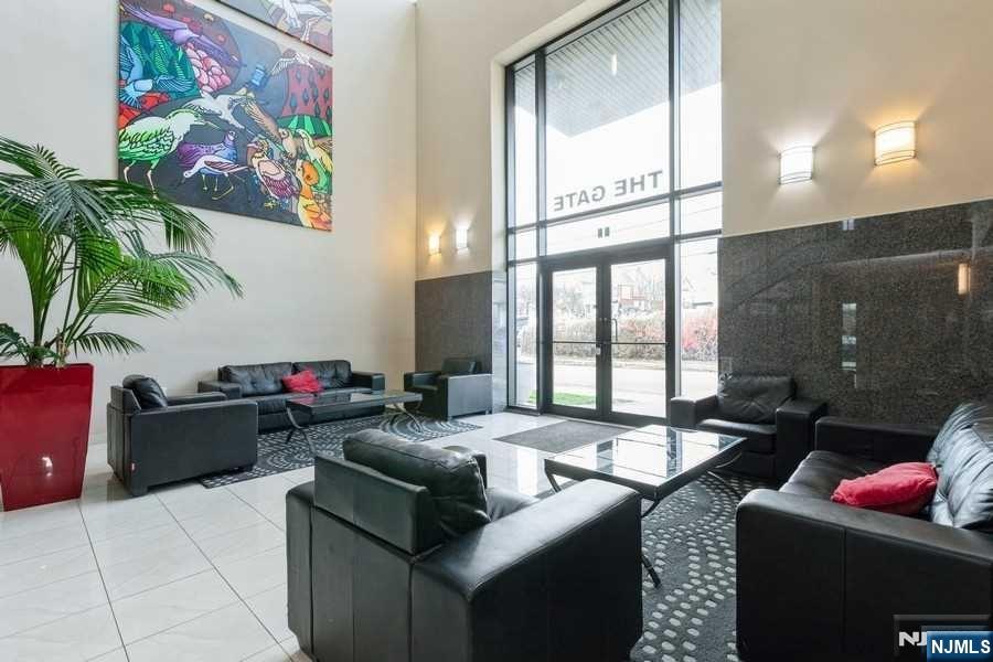 17 Meadow Road, Unit 301 Rutherford, NJ 07070 - Photo 20 of 21 a living room with furniture and a floor to ceiling window