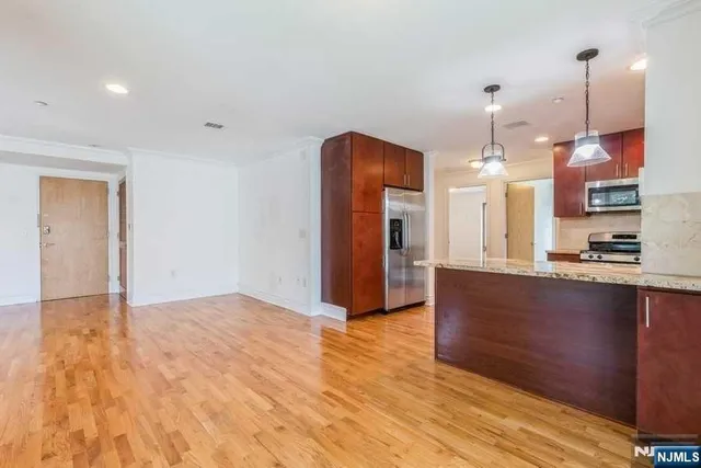 a view of kitchen and hall with wooden floor