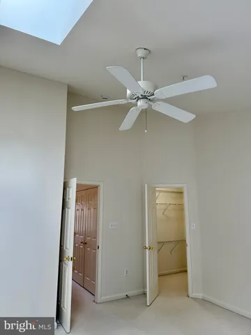 a view of a room with a ceiling fan and closet