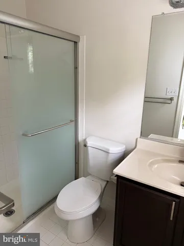 a white toilet sitting next to a bathroom sink