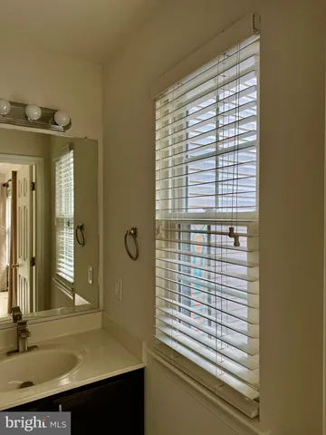 a view of a bathroom with a sink and a window
