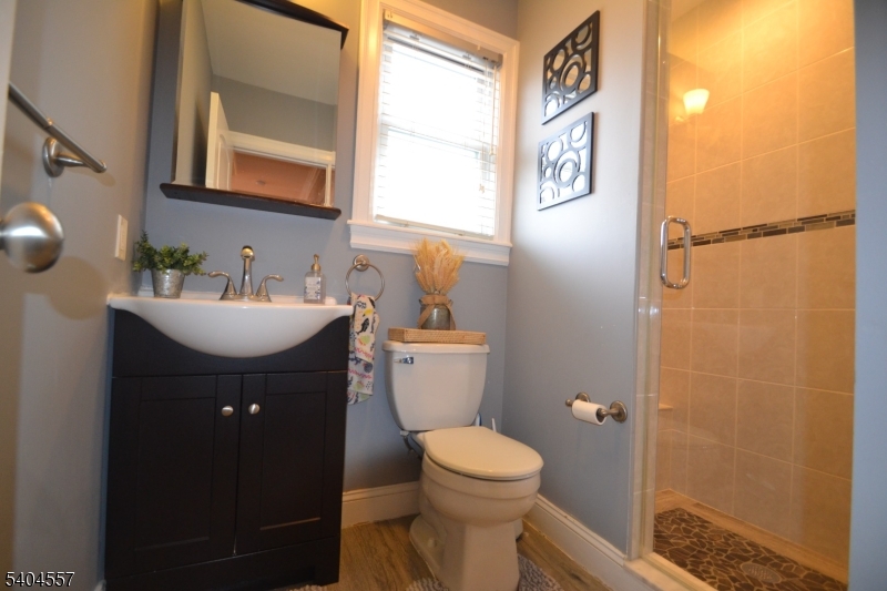 204 Market Street Garfield, NJ 07026 - Photo 12 of 36 a bathroom with a sink and mirror with toilet