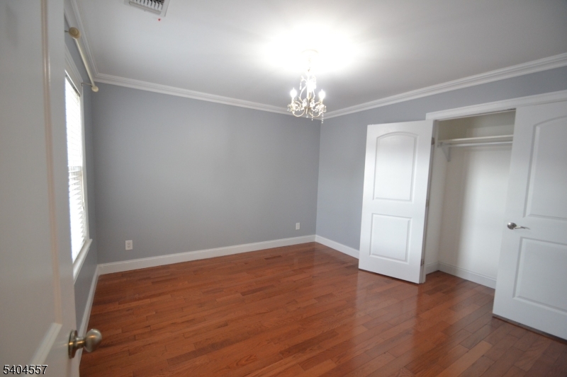 204 Market Street Garfield, NJ 07026 - Photo 18 of 36 wooden floor in an empty room with a window