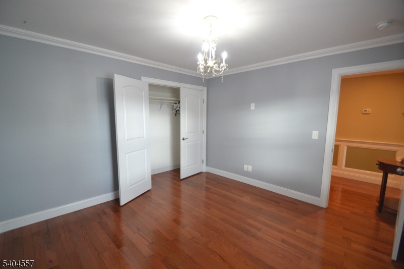 204 Market Street Garfield, NJ 07026 - Photo 19 of 36 a view of an empty room with wooden floor and a window