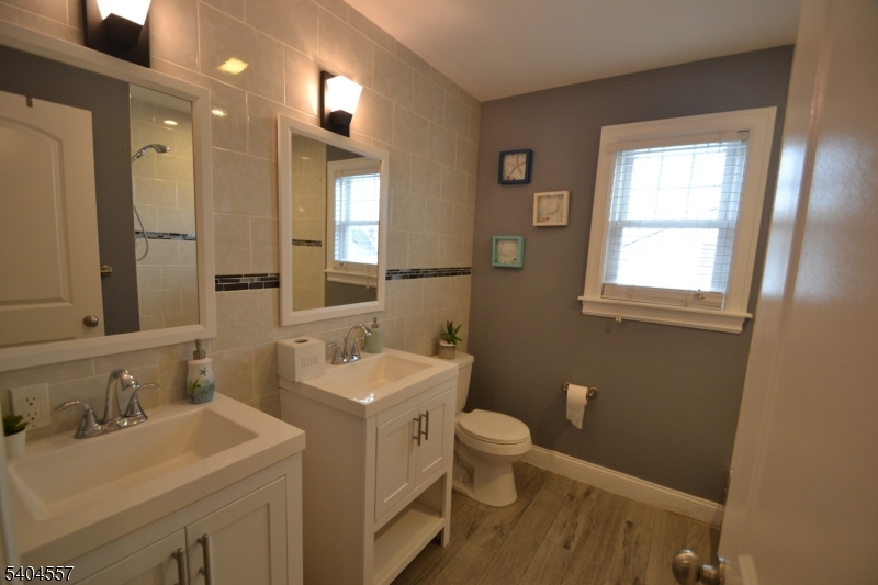204 Market Street Garfield, NJ 07026 - Photo 25 of 36 a bathroom with a sink and a mirror