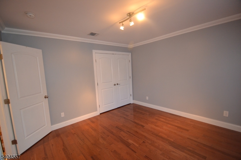 204 Market Street Garfield, NJ 07026 - Photo 30 of 36 a view of an empty room with wooden floor